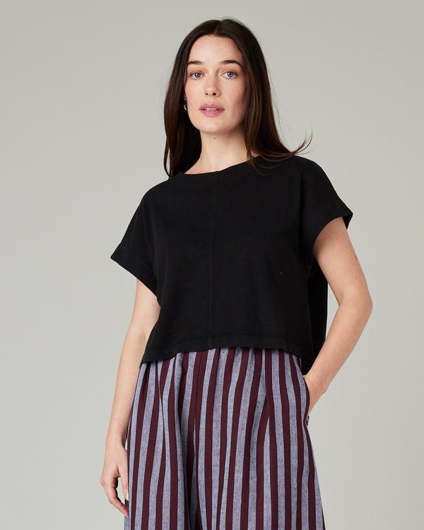 model wears black jersey polly top