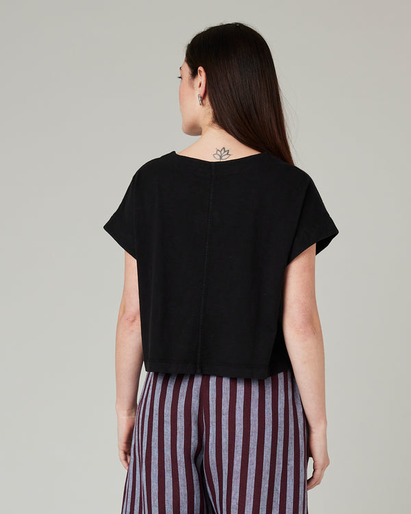 model wears black jersey polly top