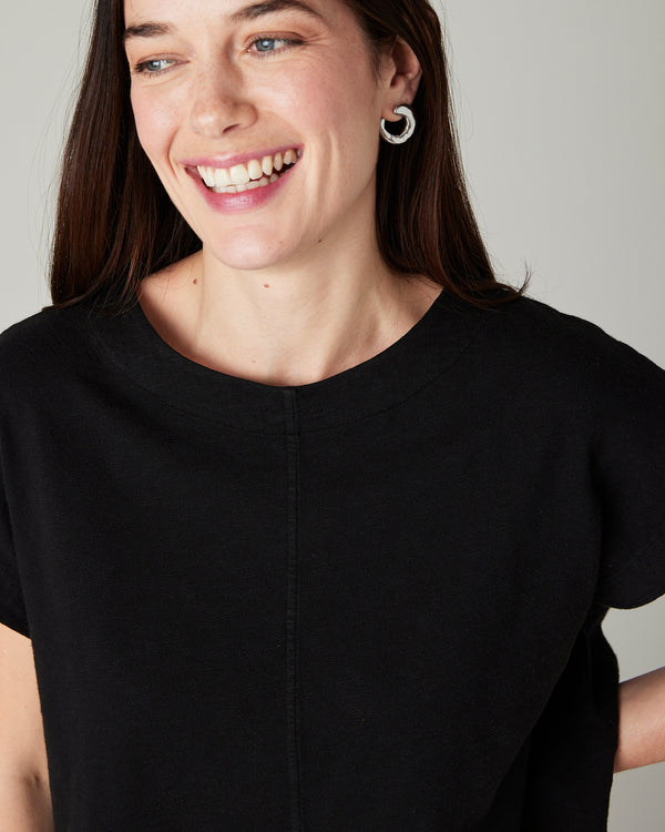 model wears black jersey polly top