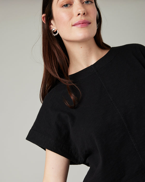 model wears black jersey polly top