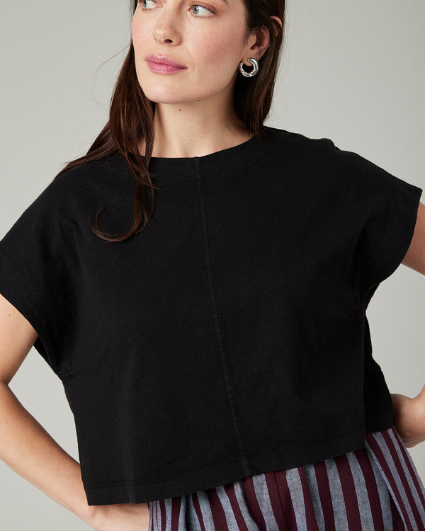 model wears black jersey polly top