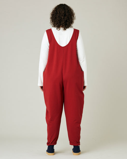 model wears cherry red poppy jumpsuit