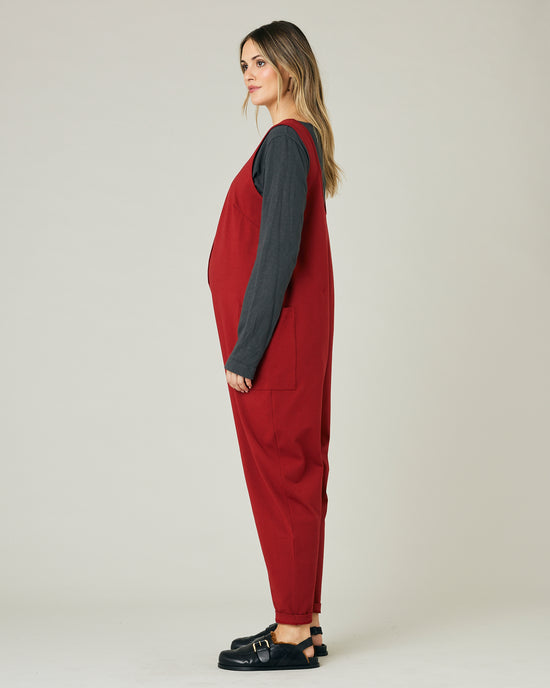 pregnant model wears cherry red poppy jumpsuit