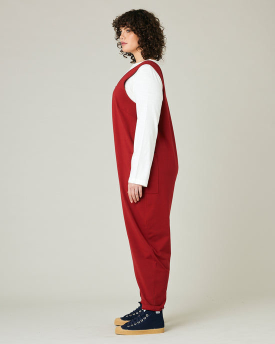 model wears cherry red poppy jumpsuit