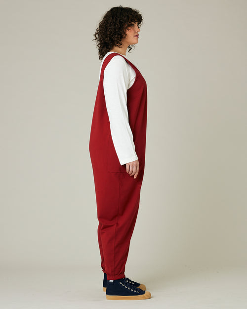 model wears cherry red poppy jumpsuit