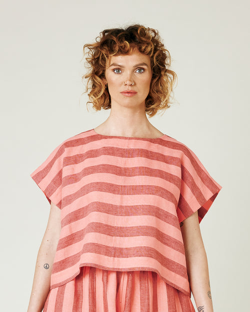 model wears blush stripe linen polly top