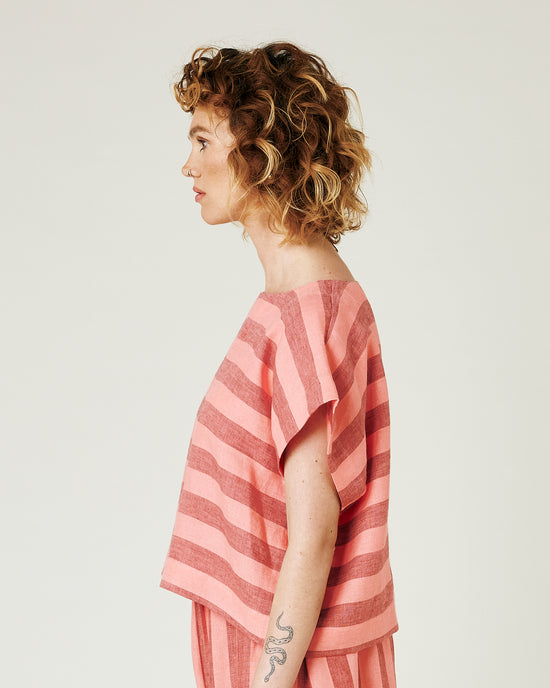 model wears blush stripe linen polly top