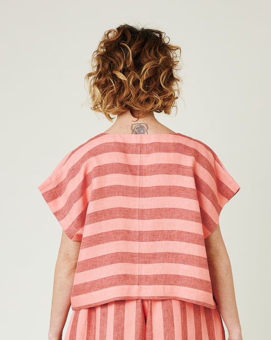 model wears blush stripe linen polly top