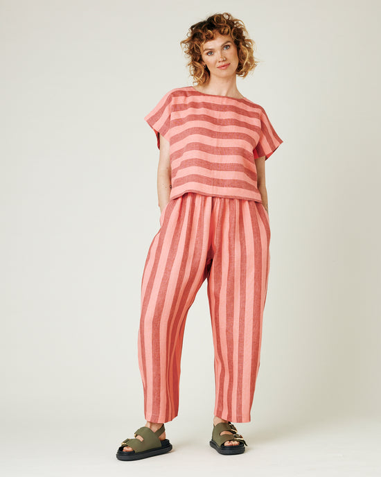 model wears blush stripe linen polly top