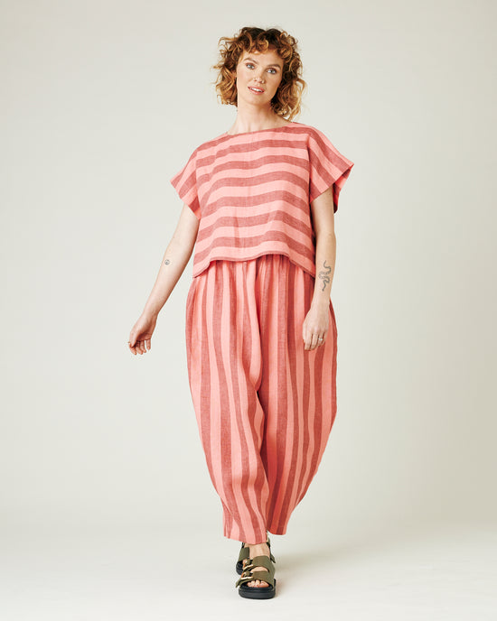 model wears blush stripe linen polly top