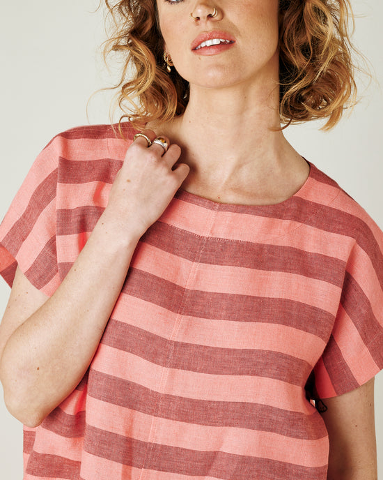 model wears blush stripe linen polly top