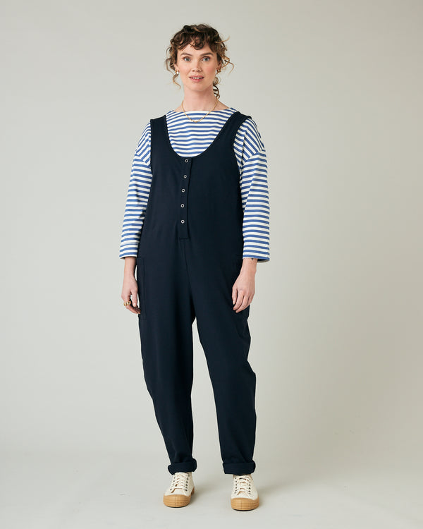 pregnant model wears navy poppy jumpsuit