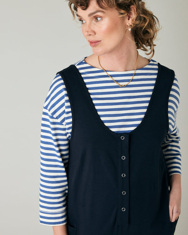 pregnant model wears navy poppy jumpsuit