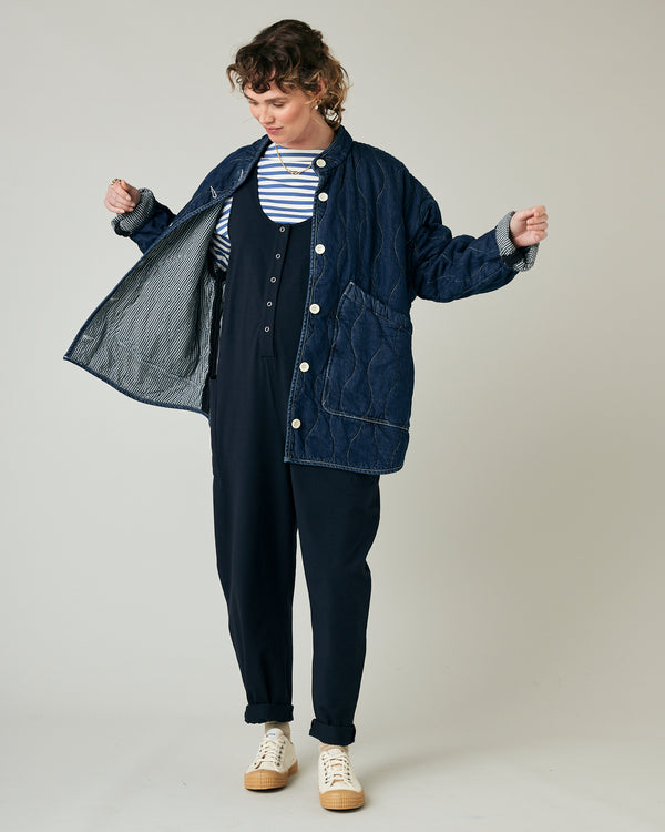 pregnant model wears navy poppy jumpsuit