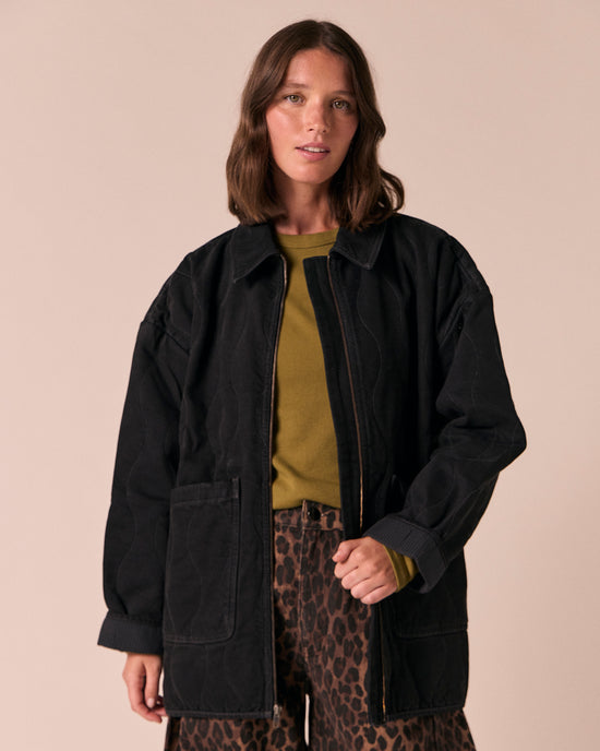 model wears raya black denim jacket