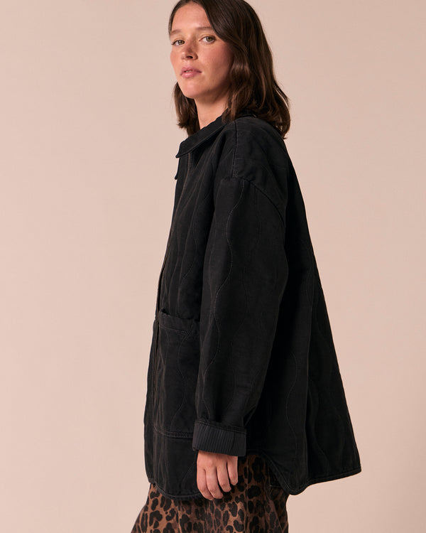 model wears raya black denim jacket