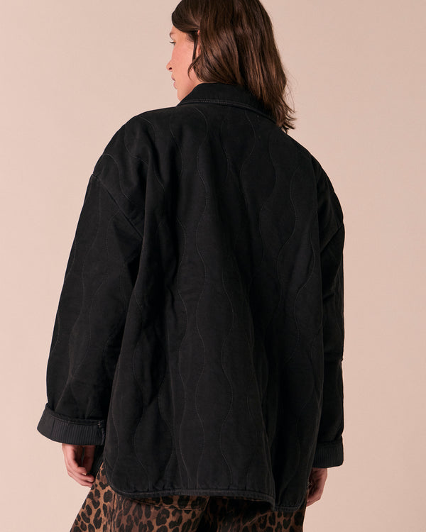 model wears raya black denim jacket