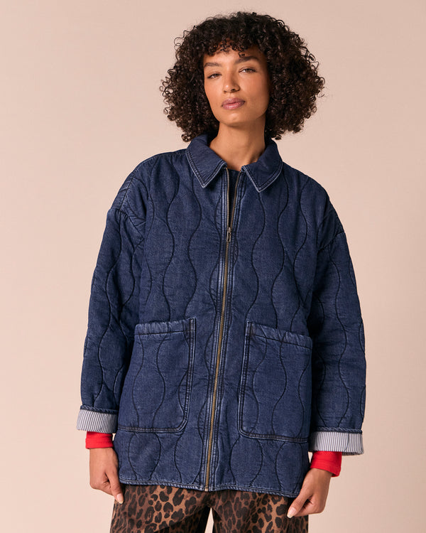 model wears raya mid blue denim jacket