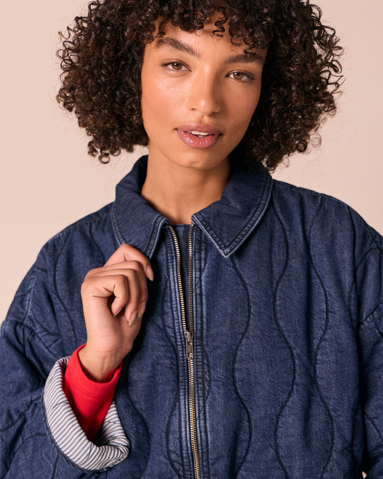 model wears raya mid blue denim jacket