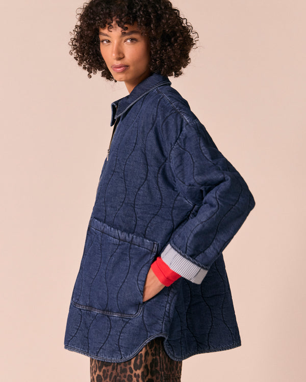model wears raya mid blue denim jacket