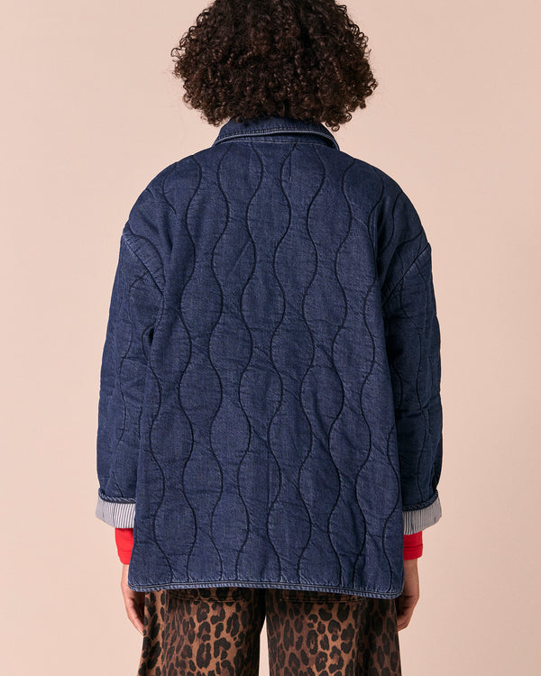 model wears raya mid blue denim jacket