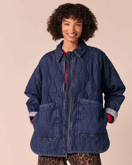 model wears raya mid blue denim jacket