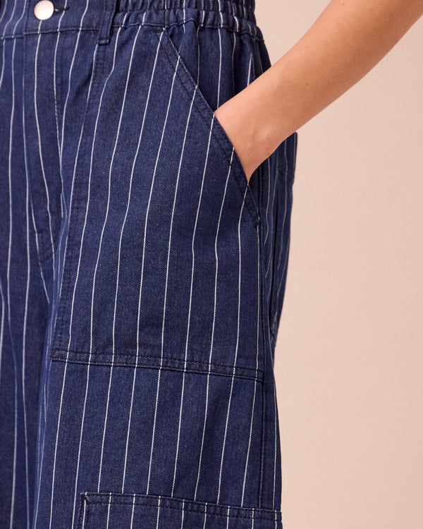 model wears reba mid blue pinstripe denim jeans 