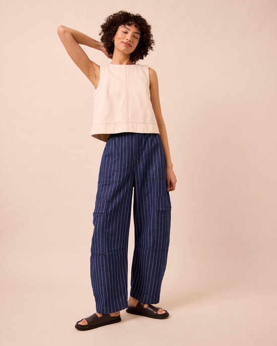model wears reba mid blue pinstripe denim jeans left