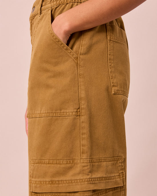 model wears reba nutmeg denim jeans left