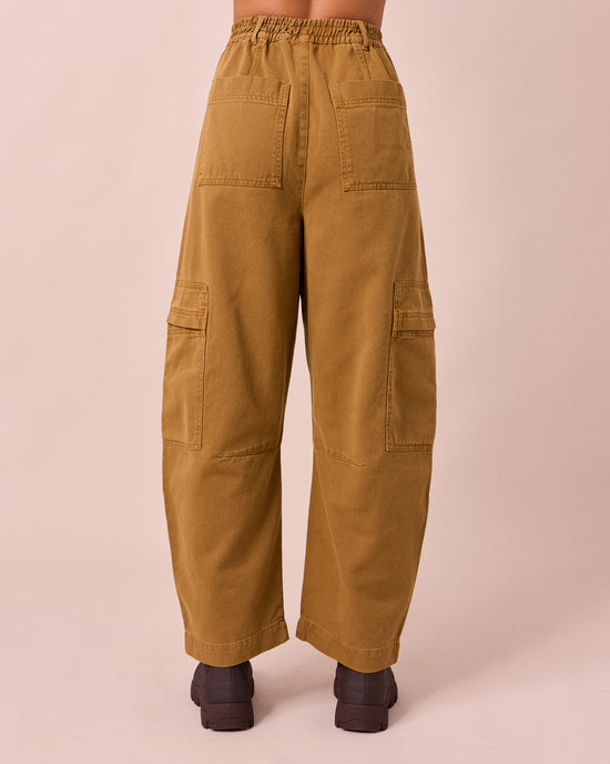 model wears reba nutmeg denim jeans back