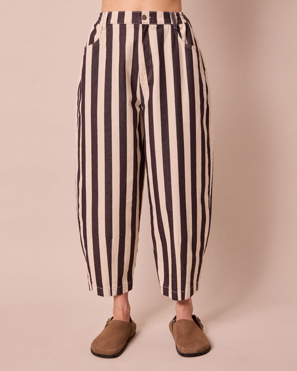 model wears remi ecru and chocolate denim jeans front