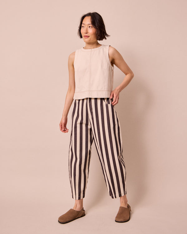 model wears remi ecru and chocolate denim jeans left