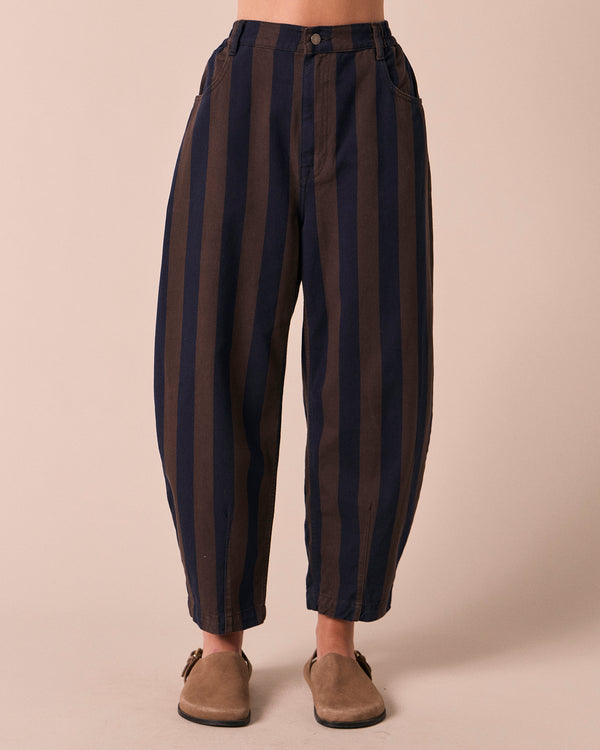 model wears remi navy and chocolate stripe denim jeans front