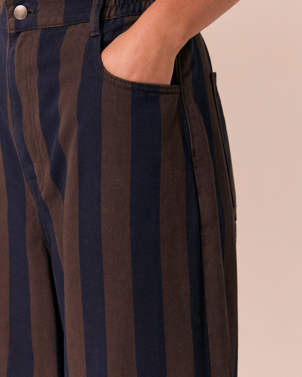 model wears remi navy and chocolate stripe denim jeans