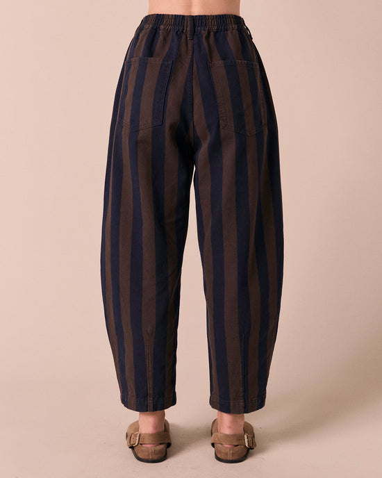 model wears remi navy and chocolate stripe denim jeans back