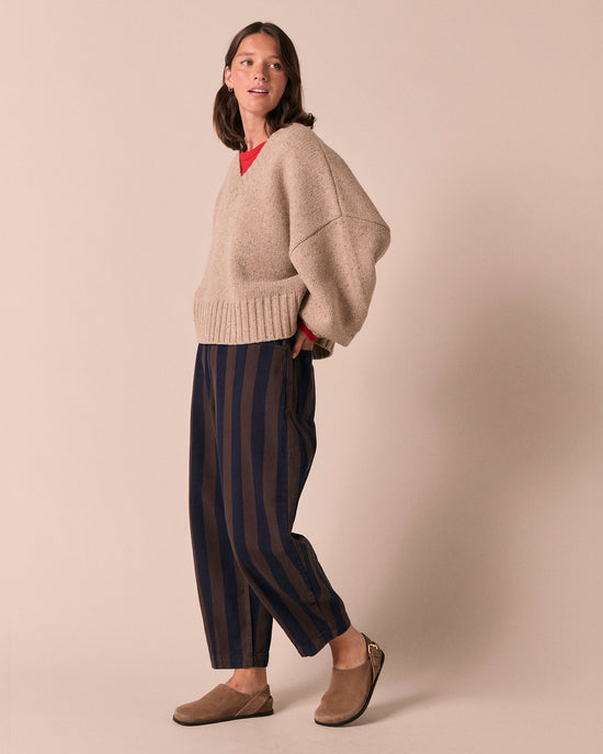 model wears remi navy and chocolate stripe denim jeans right