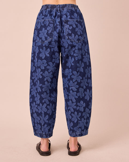 model wears remi pressed flower print denim jeans back