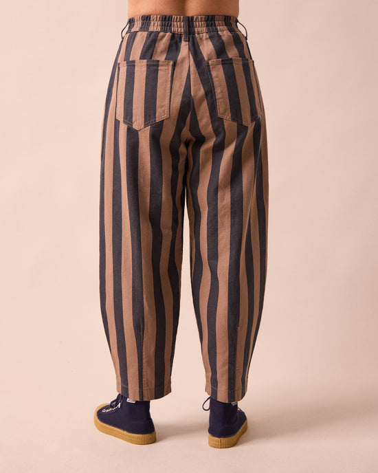 model wears remi graphite and mocha denim jeans back