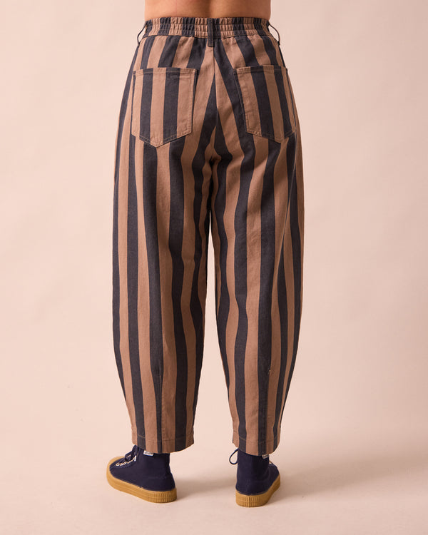 model wears remi graphite and mocha denim jeans back