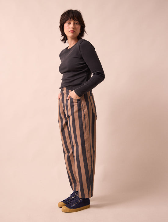 model wears remi graphite and mocha denim jeans left