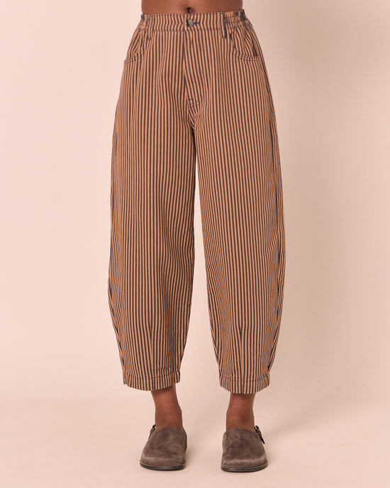 model wears remi nutmeg pinstripe denim jeans front