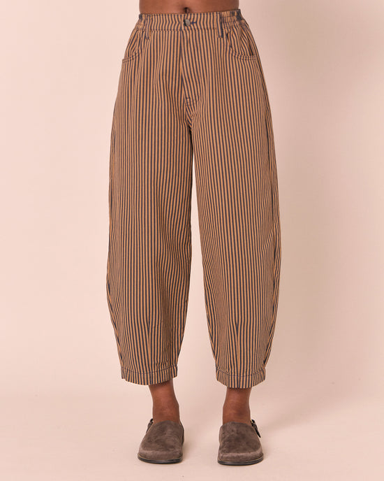 model wears remi nutmeg pinstripe denim jeans front