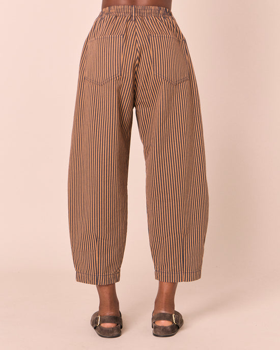 model wears remi nutmeg pinstripe denim jeans back