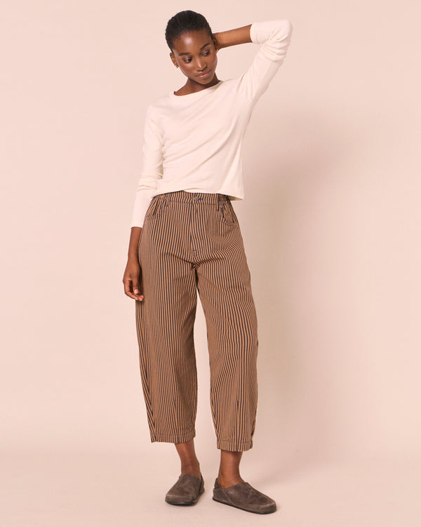 model wears remi nutmeg pinstripe denim  jeans left
