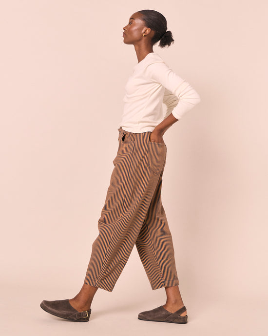model wears remi nutmeg pinstripe denim jeans right