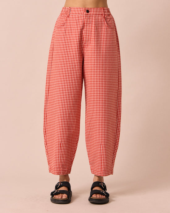 model wears remi poppy red gingham jeans