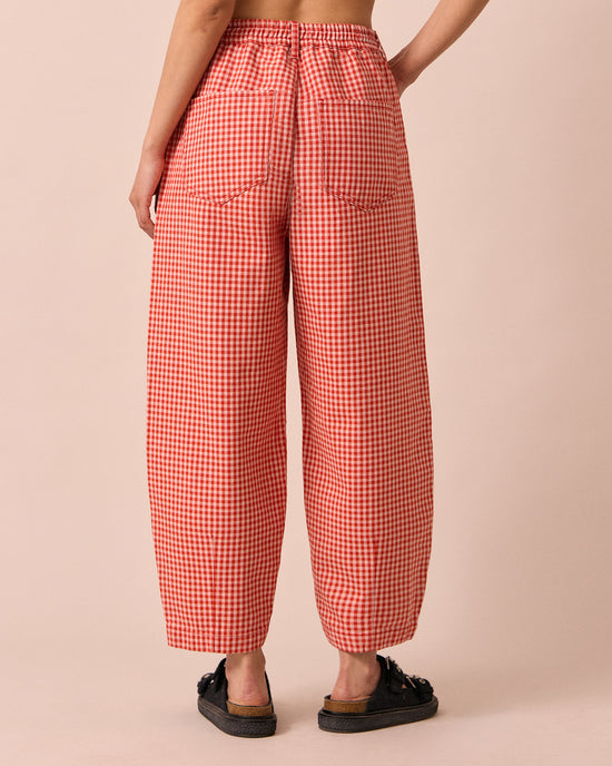model wears remi poppy red gingham jeans