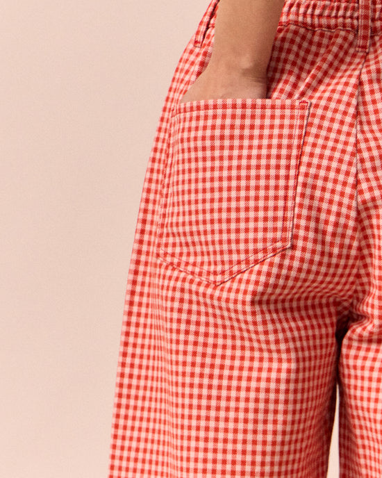 model wears remi poppy red gingham jeans
