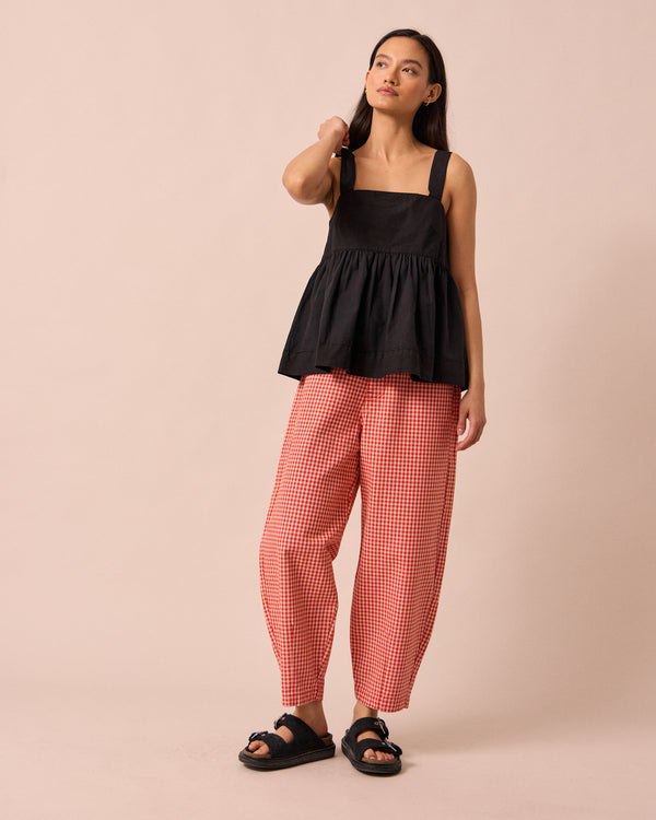 model wears remi poppy red gingham jeans
