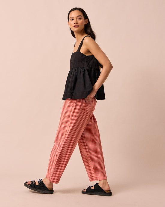 model wears remi poppy red gingham jeans